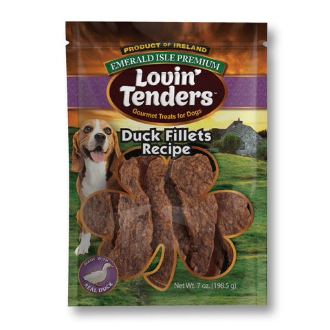 A 7 oz bag of Lovin' Tenders Duck Fillets Recipe dog treats on a white background. The packaging features a green landscape with a stone house, a beagle dog, and a shamrock-shaped cutout showing the brown textured treats inside.