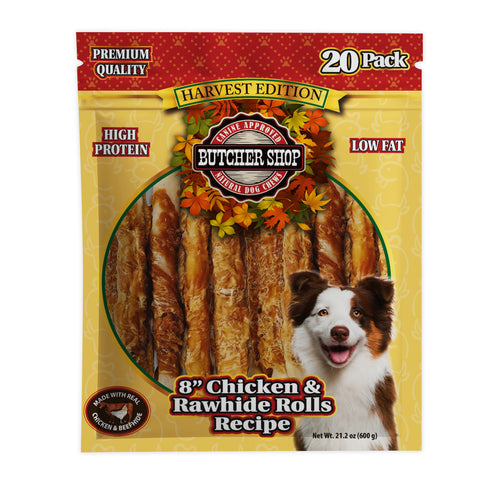 A 20-pack bag of Butcher Shop Harvest Edition dog treats, featuring 8-inch chicken and rawhide rolls. The packaging is yellow and red with a circular window showing the treats, and a smiling dog is pictured on the lower right.