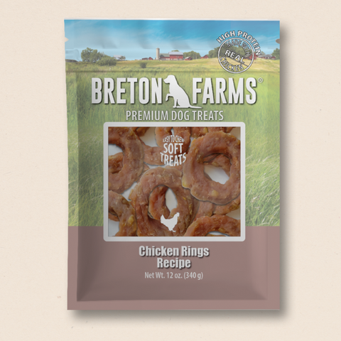 Package of Breton Farms premium dog treats featuring chicken rings. The package is 12 oz and has a clear image of the treats against a green background.