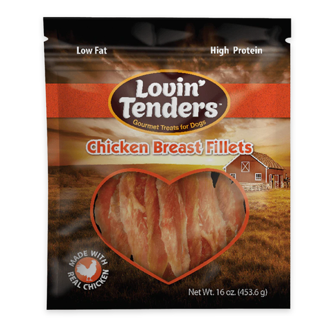 A package of Lovin' Tenders Chicken Breast Fillets dog treats, featuring a heart-shaped window showing the raw meat inside, set against a background of a farm field and barn.