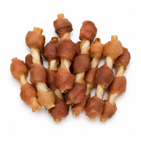 A pile of dog chew treats shaped like twisted bones, featuring alternating light tan and medium brown sections, photographed on a solid white background.
