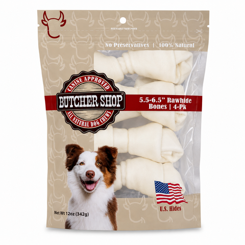 A package of butcher shop rawhide dog bones, featuring a brown and white dog on the front of the beige stand-up pouch. The packaging includes a red banner, a U.