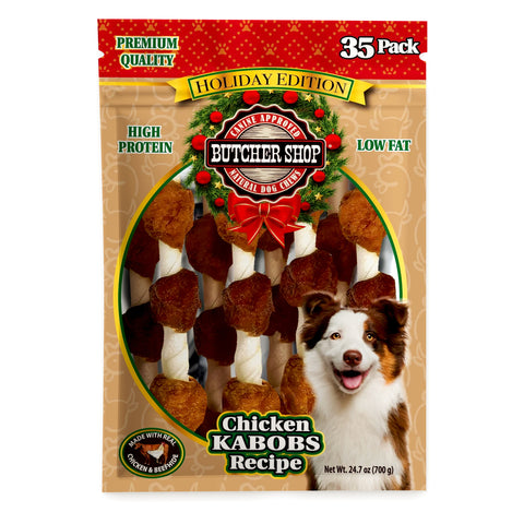 A 35-pack of Butcher Shop Holiday Edition Chicken Kaboos Recipe dog treats in a resealable stand-up pouch. The packaging features a festive red and gold holiday header, a tan patterned background, a clear window showing the brown and white bone-shaped treats, and a smiling dog on the lower right.