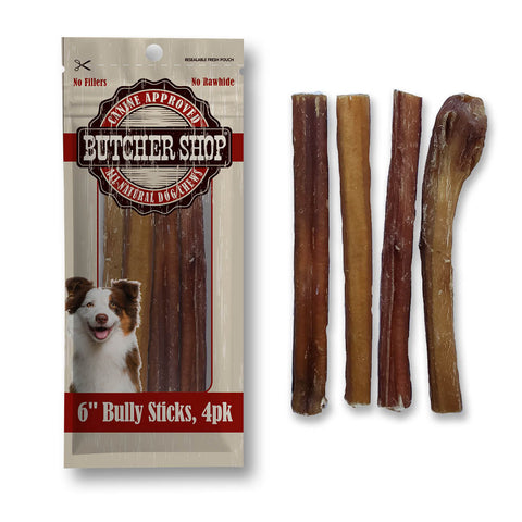 A 4-pack of butcher shop bully sticks dog treats, shown both in their retail packaging on the left and as four individual dried beef sticks on the right. The packaging features a dog illustration and a rustic wooden-textured background with red and black branding.