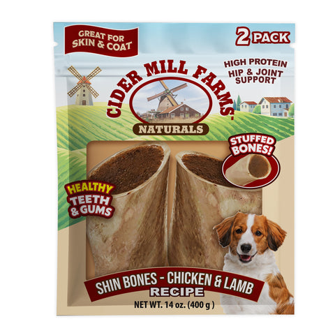 Cider Mill Farms Naturals dog chew bone packaging showing a 2-pack of Shin Bones in Chicken & Lamb recipe. The package features illustrations of a windmill and fields, a picture of a brown and white dog, and text highlighting high protein hip and joint support.