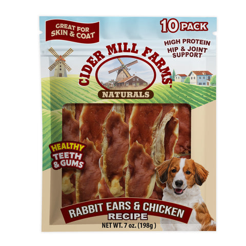 Cider Mill Farms Naturals dog chew treats in a 10-pack. The packaging features a scenic illustration of a farm with windmills, a dog graphic, and a clear window showing the rabbit ears and chicken flavored treats inside.