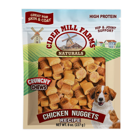 Cider Mill Farms Naturals Chicken Nuggets dog treats in a 227 g bag. The packaging features a green and blue landscape design with a windmill, a picture of a dog, and a clear window showing the golden-brown cylindrical chews inside.