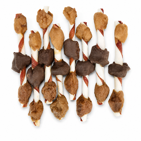 A group of dog treat sticks with white and red spiral sticks, topped with brown and dark chocolate pieces, arranged on a plain white background.