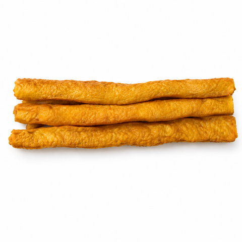 Three golden-brown, crispy do treat sticks stacked horizontally on a clean white background.